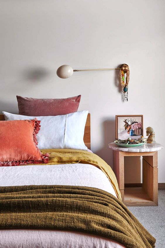 such pretty layered bedding with plenty of texture will raise your mood with cool colors and will make the space lovely