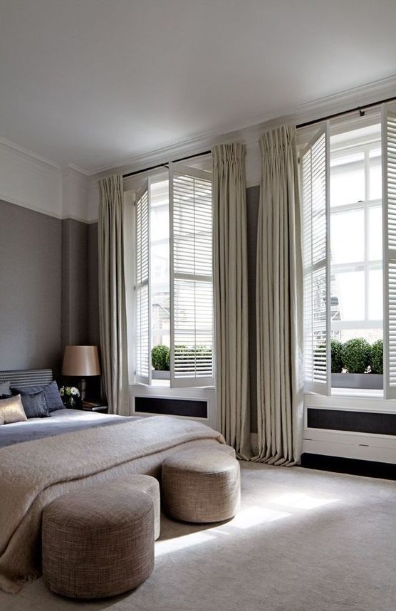 neutral shutters with matching curtains create a sophisticated and welcoming bedroom look adding charm to it