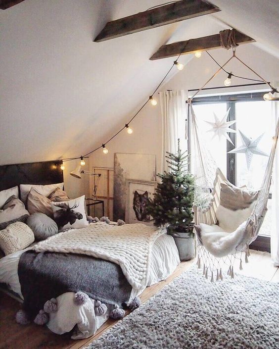 a faux fur rug and lots of pillows and layered blankets easily make this attic bedroom very welcoming and cozy