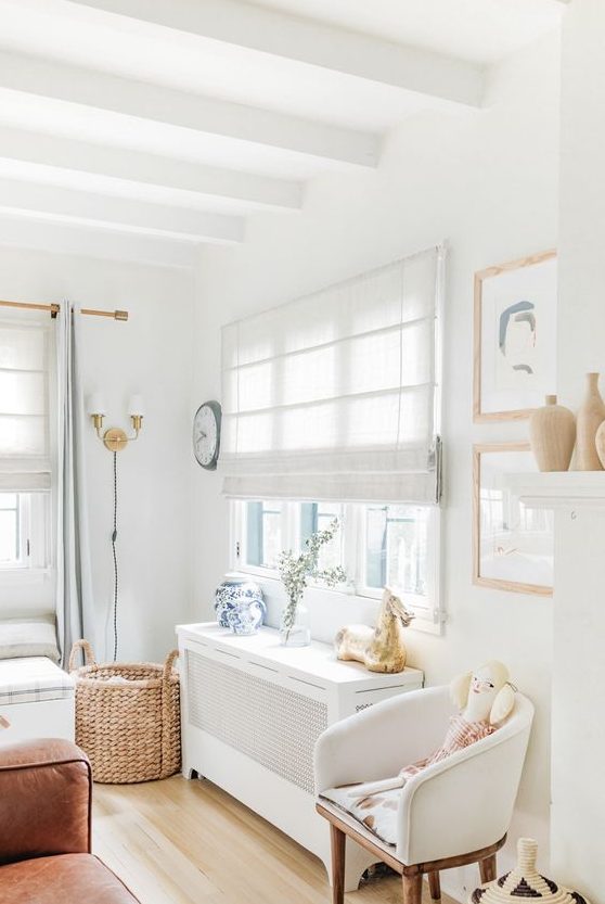 neutral fabric shades paired with light blue curtains will make this kid's room all private and still filled with light