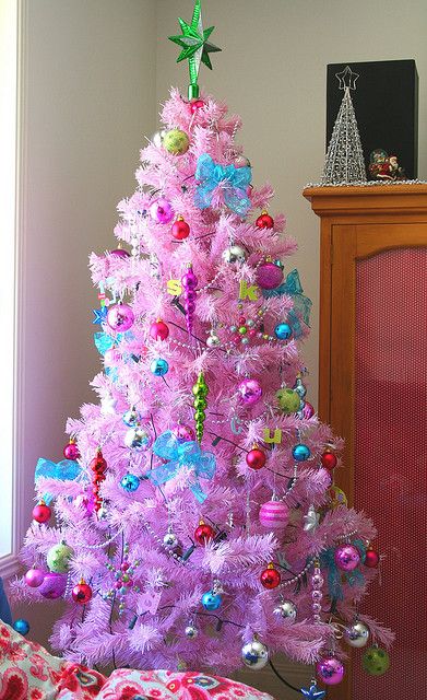 a pink Christmas tree with all colorful vintage ornaments, beads, icicles and a bold green star on top is a fun and playful decoration