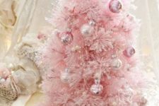 24 a pretty pink Christmas tree with shiny metallic ornaments that match in color and some pearly beads as decor