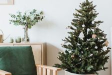 26 a modern Nordic Christmas tree in a basket, with lights and just several white Christmas ornaments is a lovely idea for your modern space