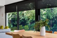 26 a stylish contrasting modern space with clerestory windows and a glazed wall treated with sleek black semi sheer blinds