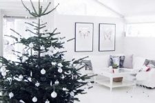 27 a modern Nordic Christmas tree with silver and white ornaments plus bows and a star on top is an airy and flowy decor idea for a modern Scandi space