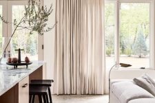 27 neutral drapes always add an airy feel to the room making it more welcoming and visually taller if you attach them to the ceiling