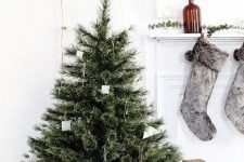 28 a modern Nordic Christmas tree with simple cardboard ornaments and metal wire ornaments that can be easily DIYed