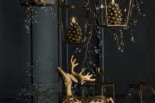 28 beautiful Christmas decor with pendant gold lanterns with pinecone candles, gold candles, a gold deer and everything black around