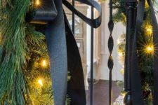 29 elegant Christmas decor with black ribbon bows, evergreens and lights is chic and simple and will bring elegance to your space