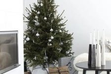 30 a modern Scandi Christmas tree with white, clear and metallic ornaments and no lights for a laconic look will do for a Nordic or minimalist space
