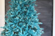 33 a gorgeous bold turquoise Christmas tree with lights in a basket – you don’t need any decor as you alreayd have a bold color statement