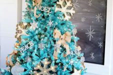 34 a fabulous turquoise Christmas tree with lights, marquee snowflakes, letter decor, burlap bows and a basket to hide the base