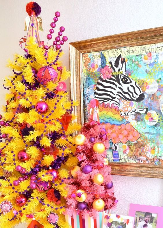 a bold yellow Christmas tree decorated with yellow and purple ornaments and beads is a crazy color statement in your space