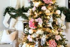 a Christmas tree with blush, pink and white blooms of a large size, gold mesh ribbon is a bold and catchy idea for a boho space