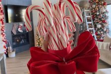 a beautiful candy cane Christmas tree topper is a very cool and bold solution that will add a lot of fun to the space