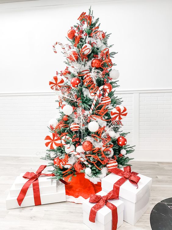 a bold and cool Christmas tree with red, white, candy cane and pepper mint ornaments is a super fun and cool solution to rock