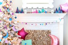 a bright galaxy mantel for Christmas, with bright color block letters, star and moon-shaped balloons and bright gift boxes
