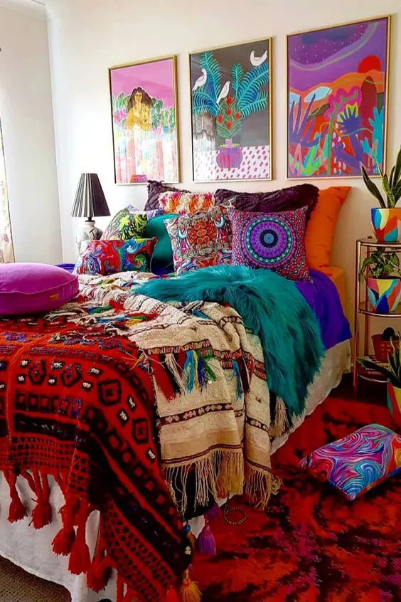 a bright maximalist bedroom with a wow factor, with a bed styled with super bright bedding, a super bold gallery wall and planters plus a rug
