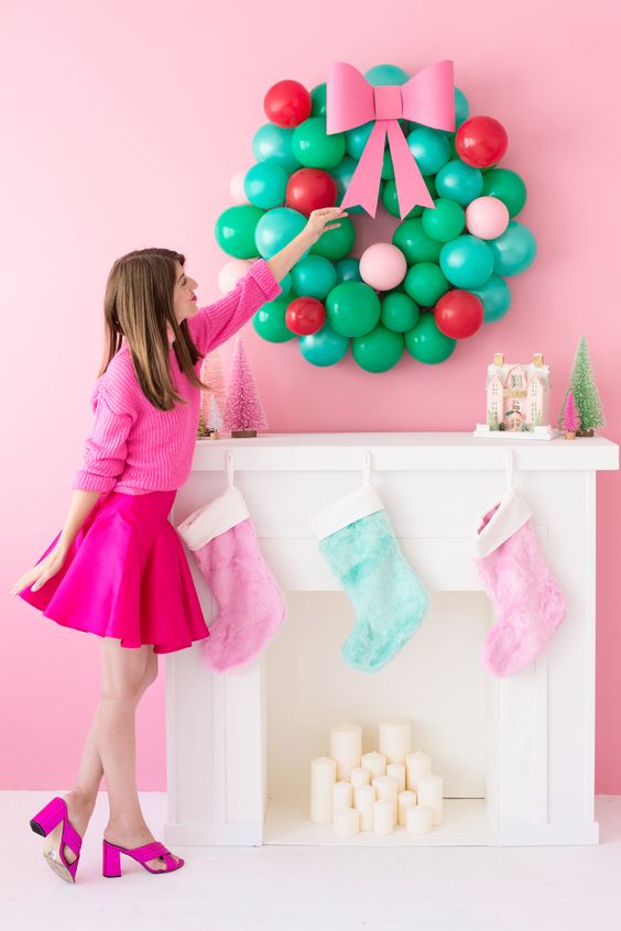 a colorful balloon Christmas wreath over the faux mantel, pastel stockings and some bottle brush trees are gorgeous for holidays