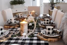 a farmhouse buffalo check Christmas tablescape with plaid linens, wood slice placemats, antlers and moss and candles wrapped with bark