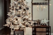 a farmhouse flocked Christmas tree with buffalo check ornaments and garlands, black and white ornaments and lights is a chic idea