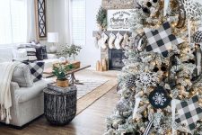 a flocked Christmas tree with lights, buffalo check stars, ornaments and garlands and snowflake ornaments is awesome for a farmhouse space