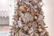a glam and shiny Christmas tree with metallic ornaments, mesh and metallic ornaments, lights, feathers and sparkles