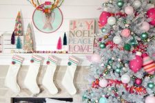 a glam white Christmas tree decorated with white, silver, blush, mint, green ornaments and bulb-shaped oversized pink ones is gorgeous