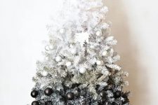 a gorgeous ombre white to black Christmas tree with perfectly matching ornaments and Xmas letters under the tree is a bold idea