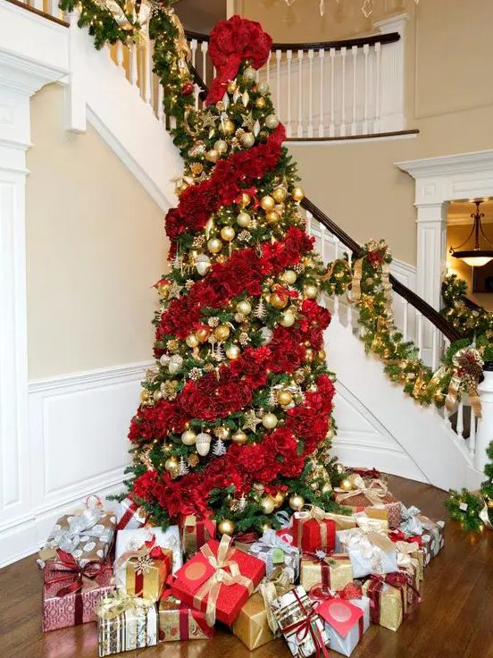a jaw-dropping Christmas tree decorated with red roses and gold ornaments in between floral garlands is magnificent