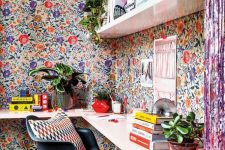 a gorgeous home office with a floral wallpaper