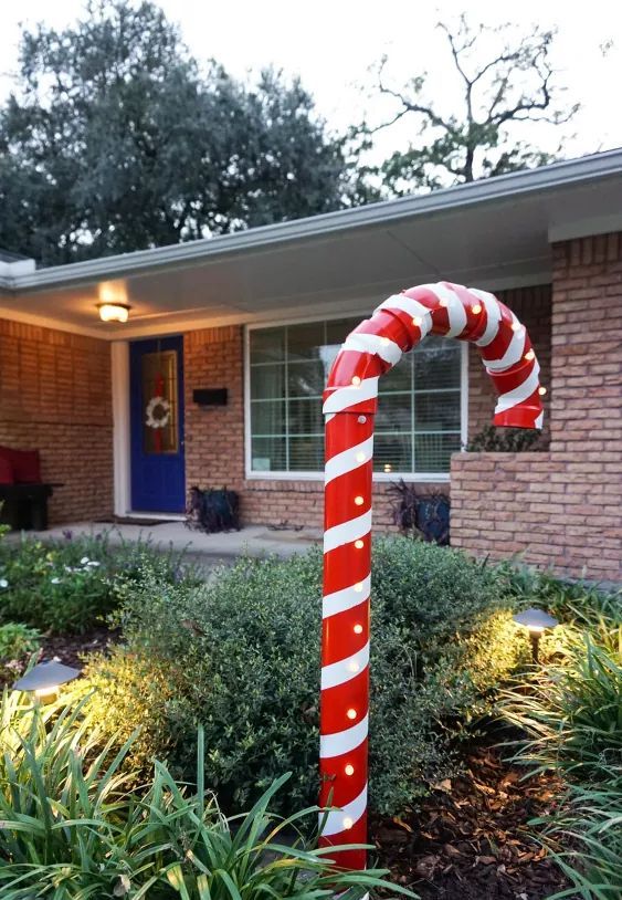 a large PVC candy cane will style your outdoor space for Christmas and it's easy to make yourself