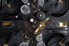 a lovely tablescape with black plates and chargers, black linens and gold touches for ultimate elegance