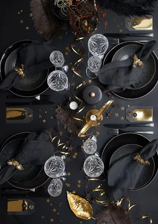 a lovely tablescape with black plates and chargers, black linens and gold touches for ultimate elegance