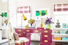 a maximalist home office in neutrals, with a hot pink desk, a bold rug, touches of turquoise and striped curtains