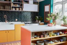 a maximalist kitchen with yellow and open cabinets, an emerald accent wall, a dark green tile backsplash and an orange kitchen island
