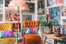 a maximalist living room with an orange and mustard chair, bright printed rugs and a jaw-dropping gallery wall that takes two walls