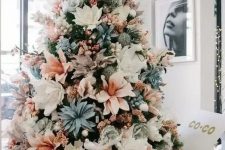 a pastel Christmas tree with white, blush, pale blue fabric blooms and some pink garlands is a unique idea to go for