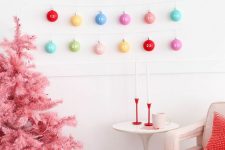 a pink Christmas tree and a creative advent calendar made of lots of colorful Christmas ornaments, which is a fun and cool idea