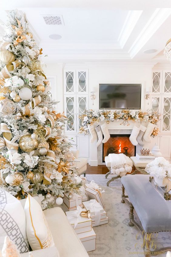 a refined glam Christmas tree with oversized gold and white ornaments, smaller silver ones and fabric blooms is gorgeous