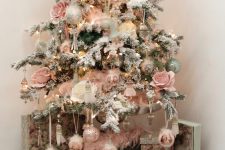 a refined vintage Christmas tree with lights, pink roses and silver, pink and green ornaments and fluffy pink garlands