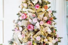 a romantic Christmas tree decorated with gold mesh ribbons, lights, gold and silver ornaments, pink, blush and hot pink blooms