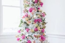 a romantic white Christmas tree decorated with hot pink and blush blooms, leaves and gilded foliage is super elegant