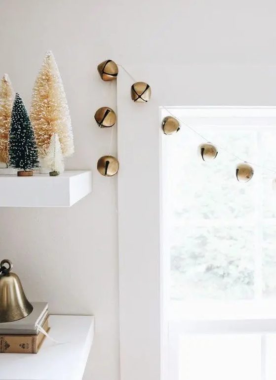 a simple garland of gold Christmas bells is a lovely and chic idea that will easily bring festive spirit to the space