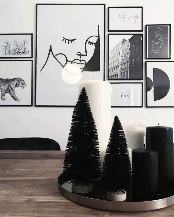 a tray with black bottle cleaner trees and black adn white pillar candles is a modern and laconic decoration for Christmas