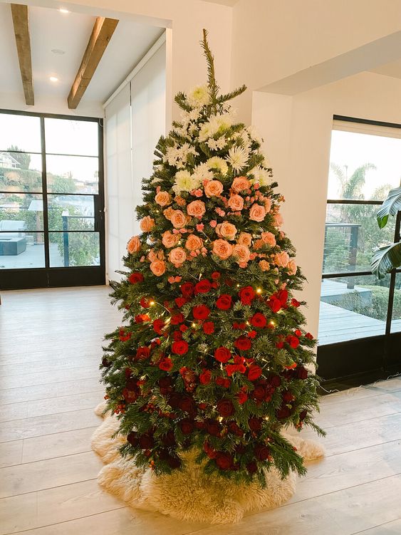 an exquisite Christmas tree with ombre floral decor - white, pink, red and burgundy blooms and lights is a bright idea