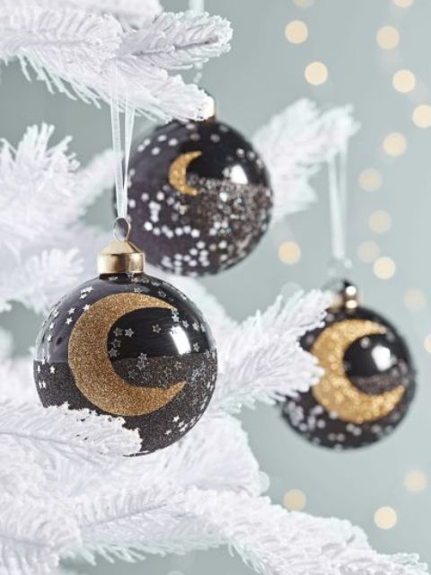 celestial Christmas ornaments, black baubles with silver stars and gold glitter half moons is a cool solution