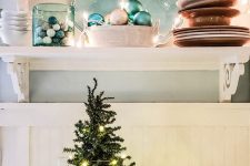 coastal Christmas decor with aqua and blue decor – jars, ornaments, a tray with a small Christmas tree and baubles