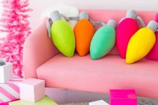 colorful vintage lights pillows, bold Christmas gift boxes and a hot pink Christmas tree will make your space ultimate