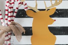 crochet candy canes in a jar and a striped sign plus a deer silhouette make up a lovely Christmas decoration